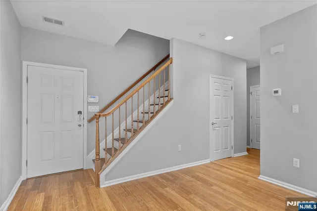 a view of an entryway with wooden floor