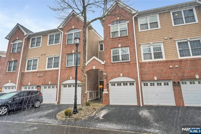 a front view of a building with parking area