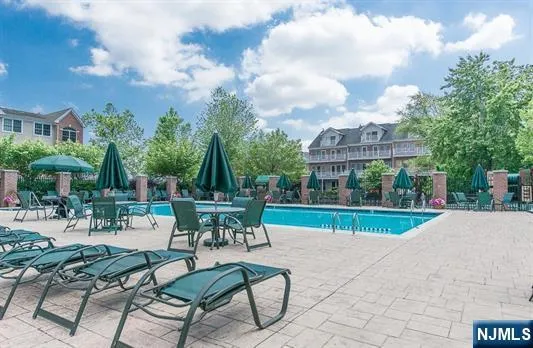 a view of house with a yard and sitting area