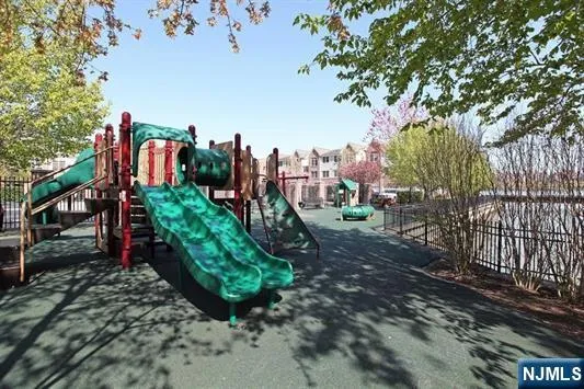 a view of a park with plants and large trees