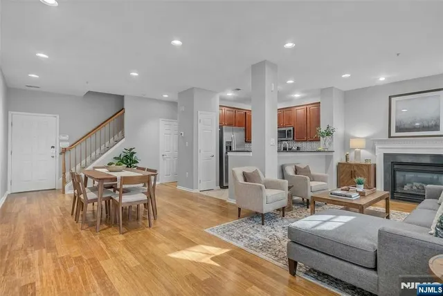 a living room with fireplace furniture and a wooden floor