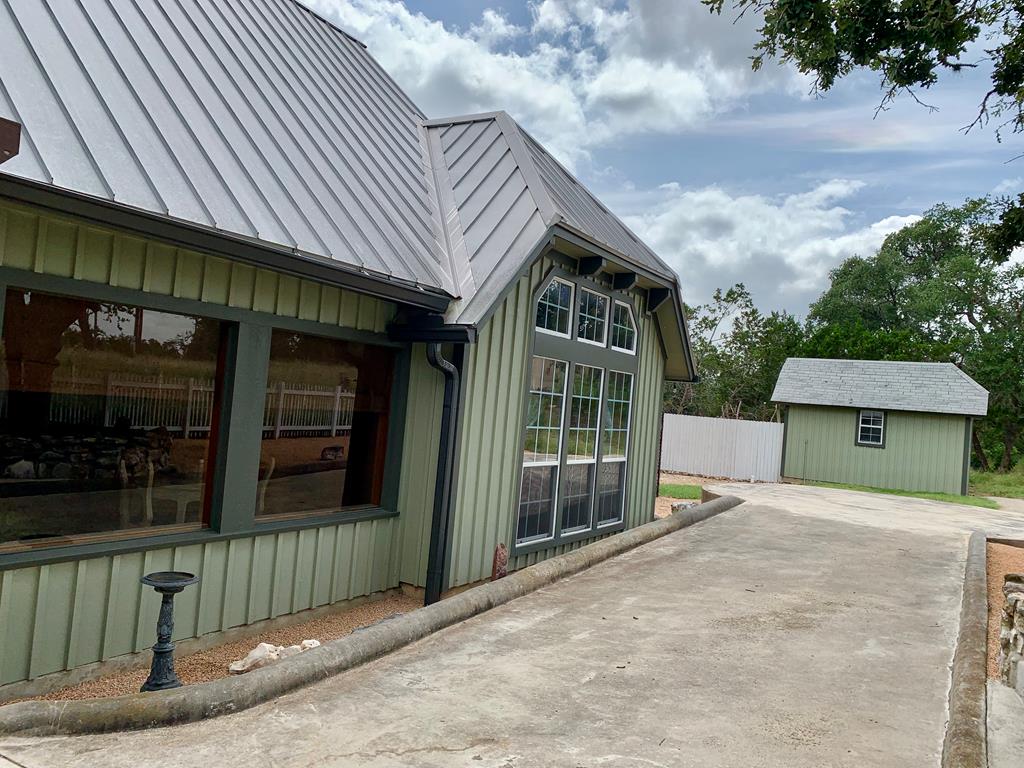 105 Fir Road Fredericksburg, TX 78624 - Photo 4 of 30 side of home, storage shed and well house