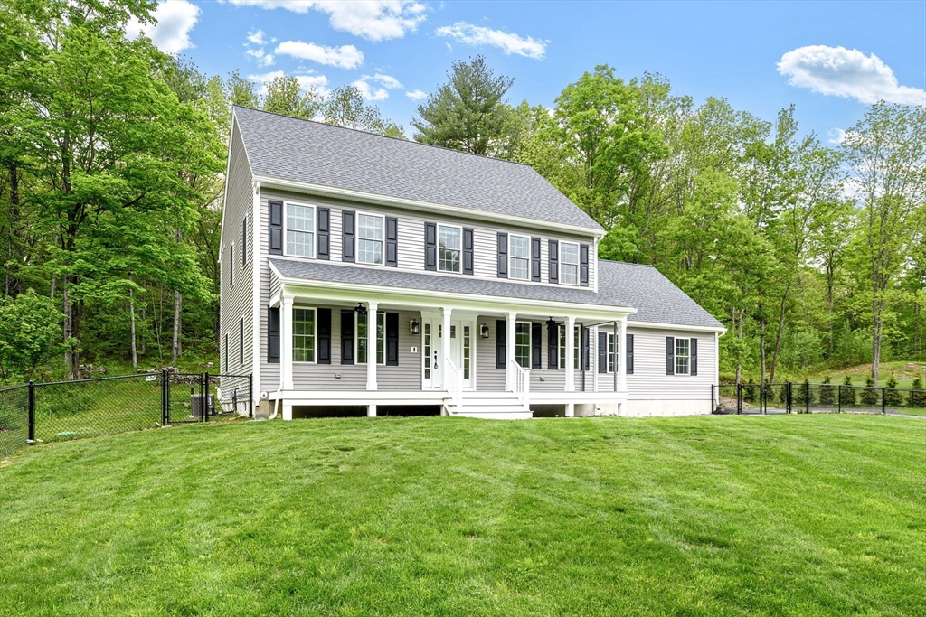 a front view of a house with a yard table and chairs
