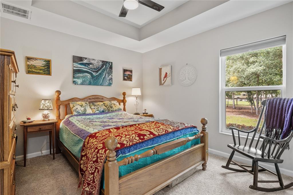 12929 Southwest 89th Street Dunnellon, FL 34432 - Photo 25 of 76 a bedroom with a bed and a view of chair