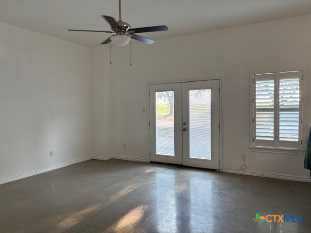 17307 Old 81, Unit C Troy, TX 76579 - Photo 2 of 7 an empty room with wooden floor chandelier fan and windows