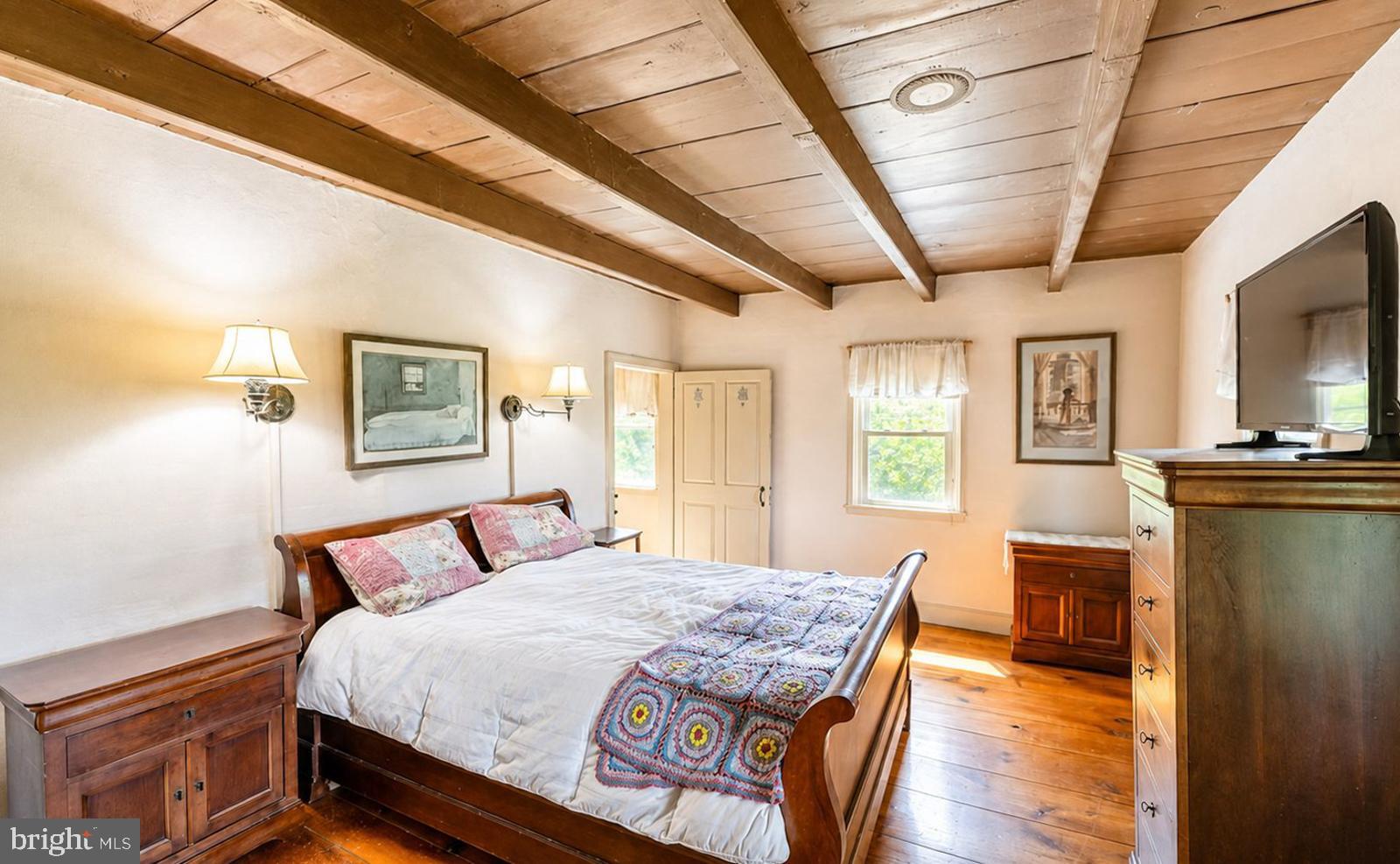 222 Blue School Road Perkasie, PA 18944 - Photo 33 of 77 a bedroom with a bed and wooden floor
