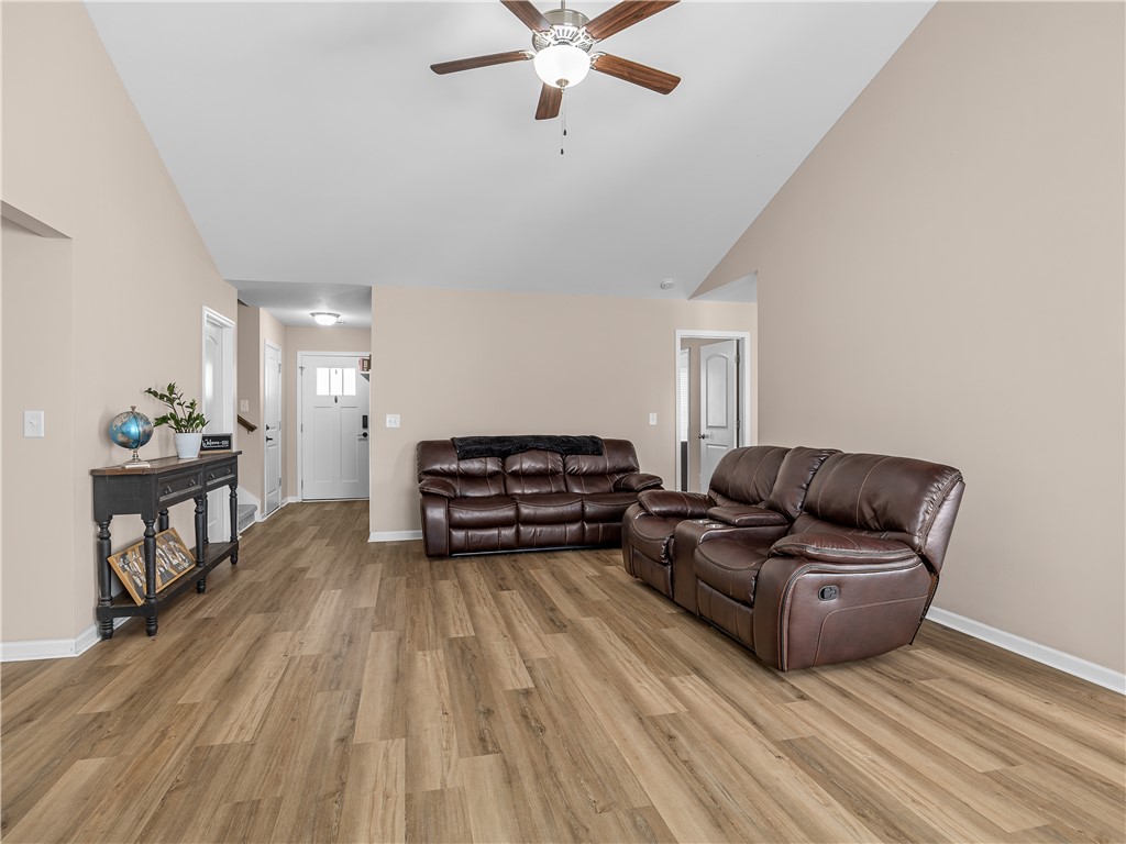 2520 Linmar Circle Anderson, SC 29621 - Photo 12 of 50 A spacious living room features vaulted ceilings and wood-look flooring.