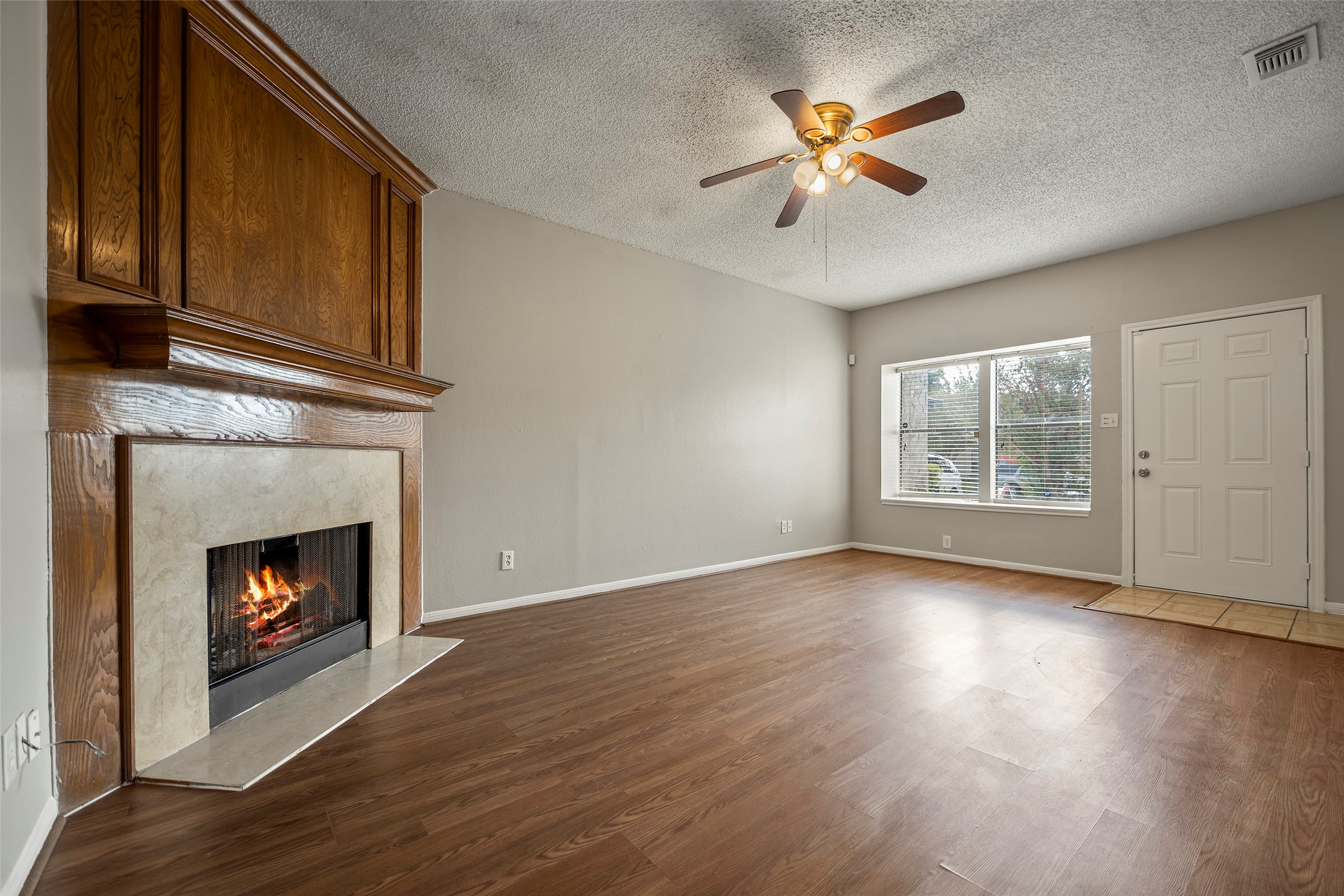 7120 Deer Creek Court Spring, TX 77379 - Photo 9 of 23 Beautiful fireplace adorning the living room. The fire is virtually created