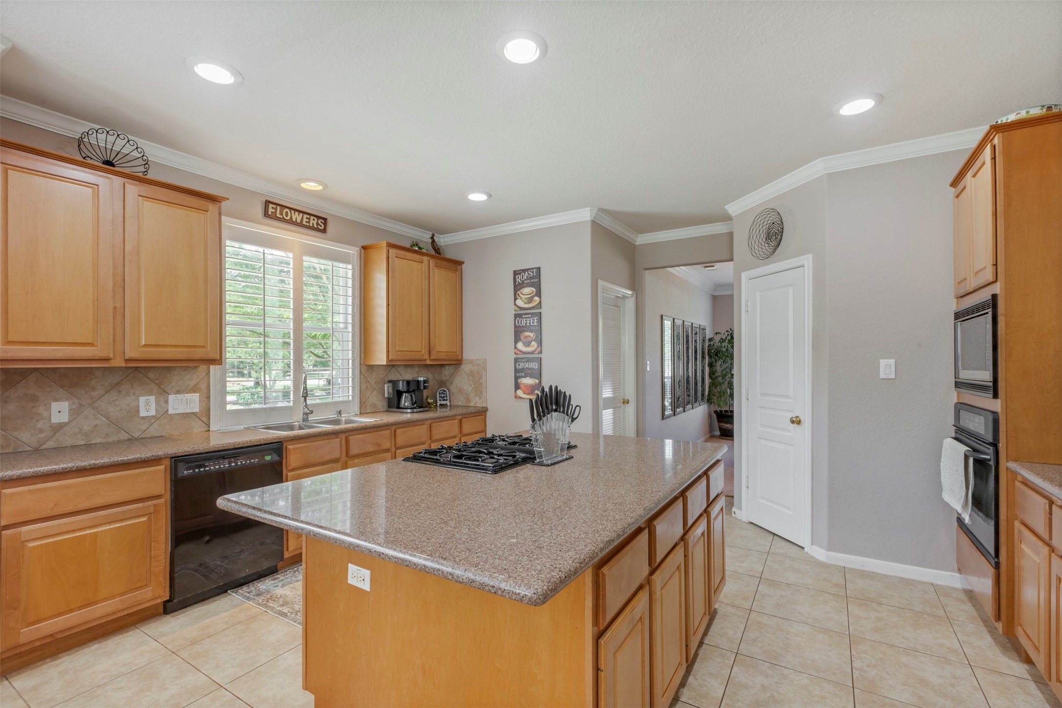 1120 Silveridge Conroe, TX 77304 - Photo 17 of 39 a kitchen with kitchen island granite countertop a sink and a refrigerator