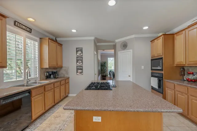 a kitchen with stainless steel appliances granite countertop sink stove and refrigerator