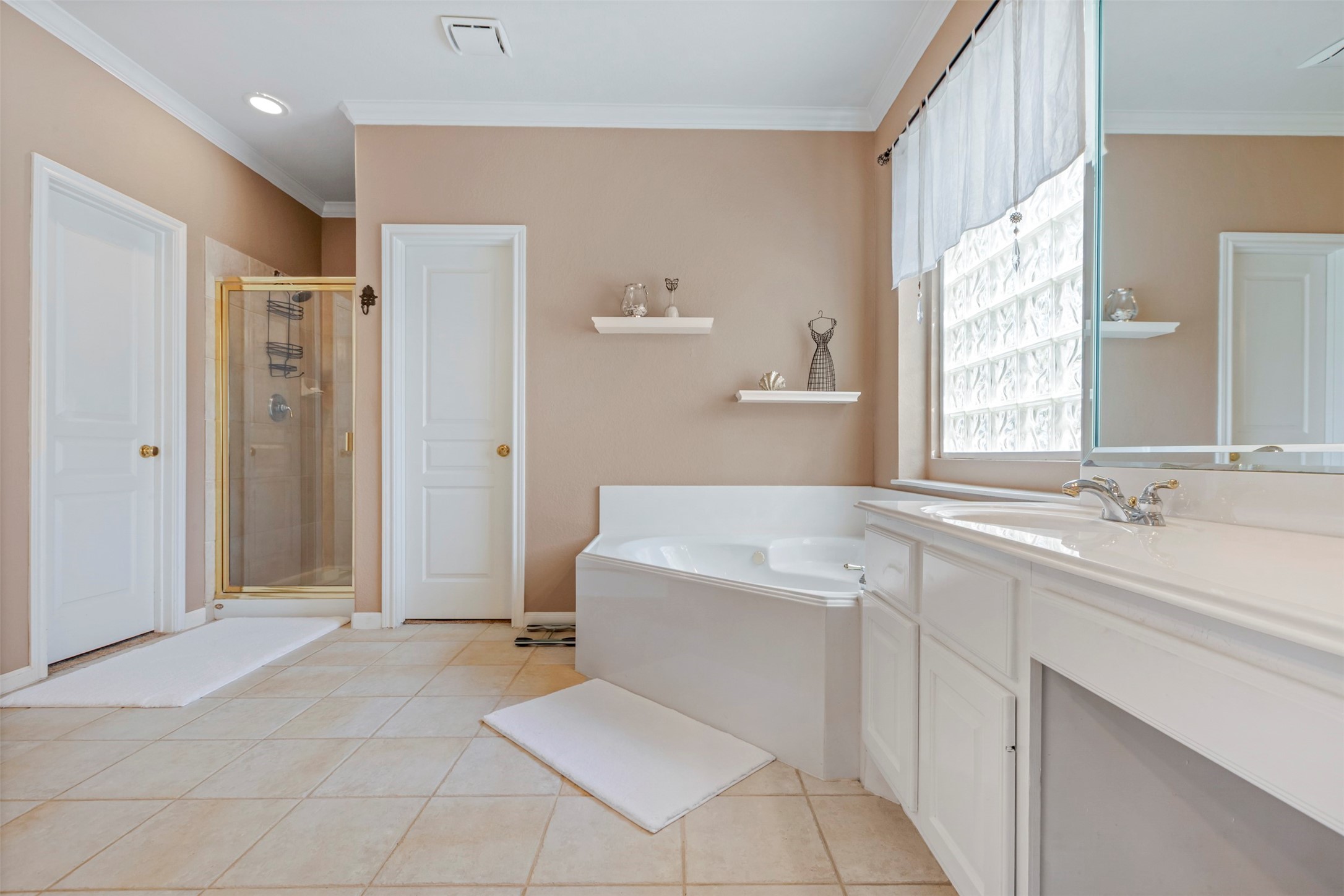 1120 Silveridge Conroe, TX 77304 - Photo 23 of 39 a spacious bathroom with a bathtub sink and mirror