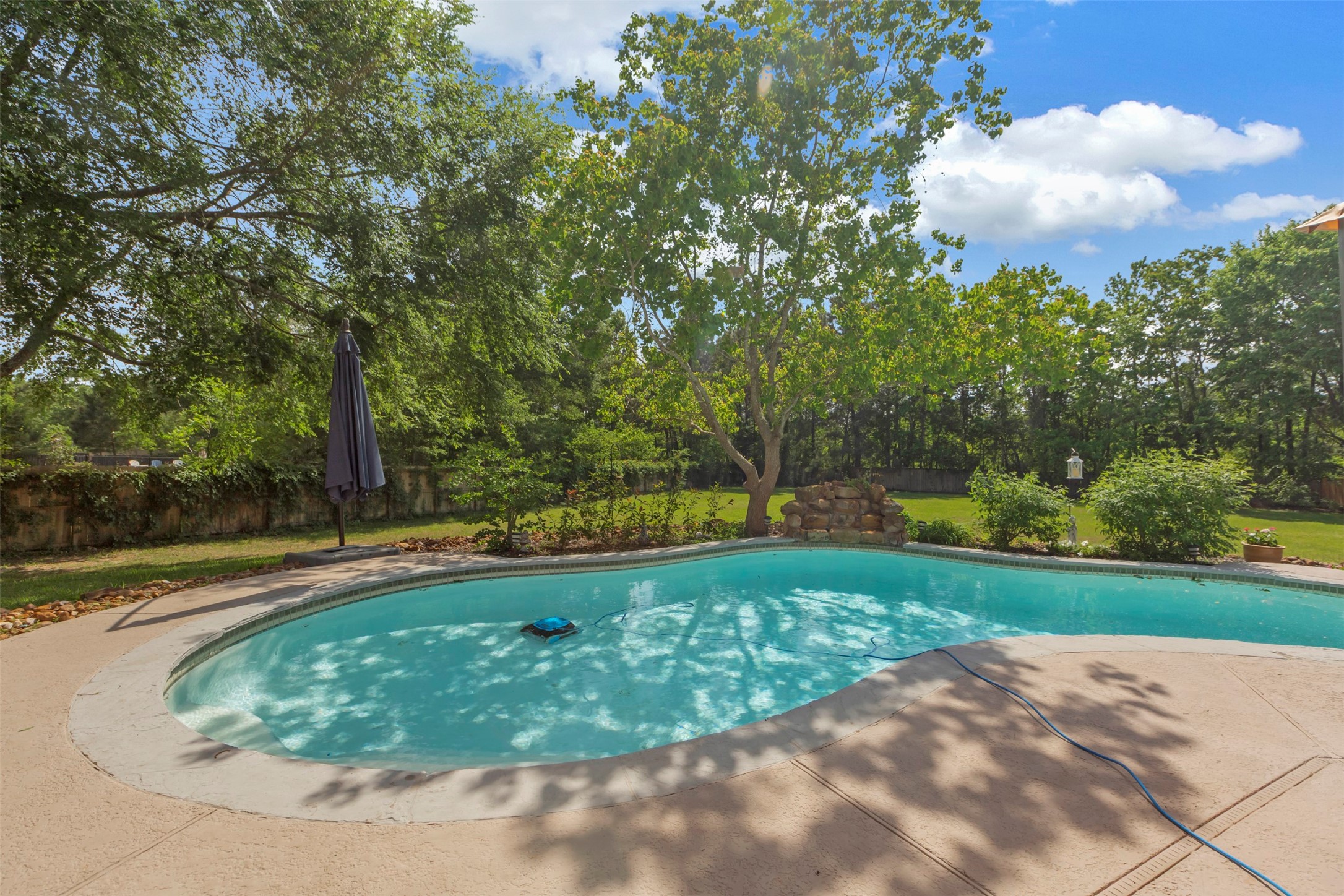 1120 Silveridge Conroe, TX 77304 - Photo 36 of 39 a view of a swimming pool with a yard and plants