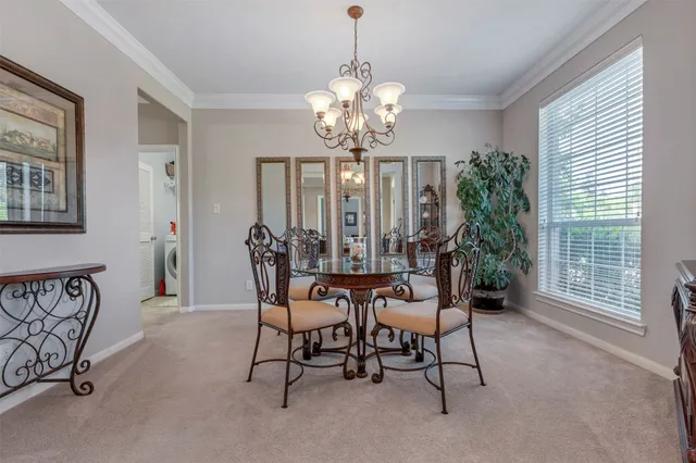 a view of a dining room with furniture and a chandelier