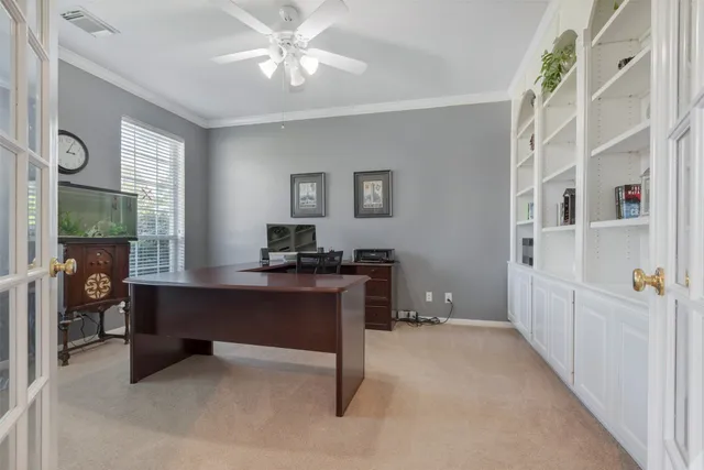 a view of a workspace with furniture and a window