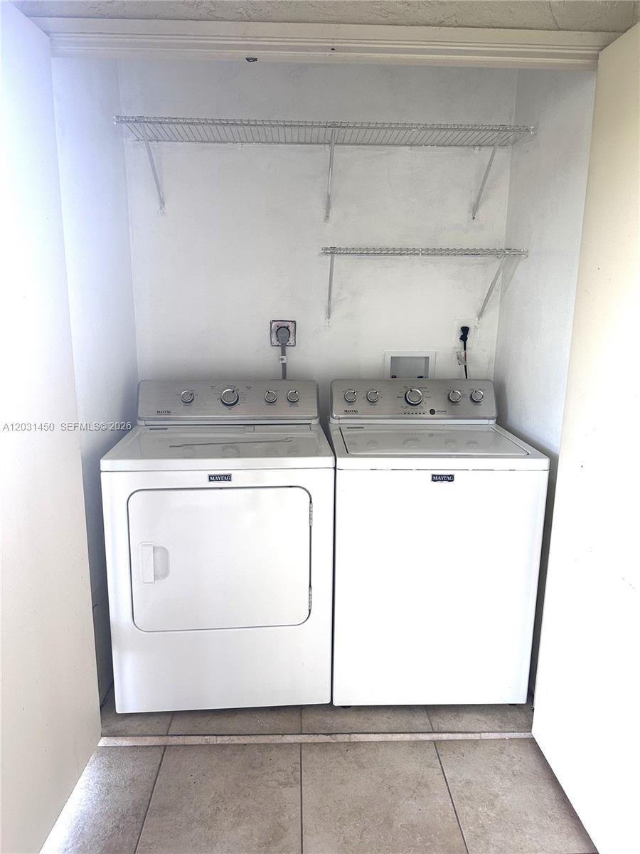 23398 Lyons Road, Unit 309 Boca Raton, FL 33428 - Photo 14 of 16 a utility room with dryer and washer