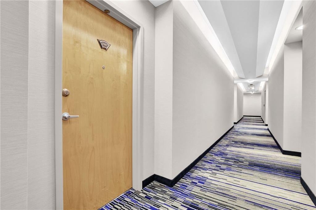 3324 Peachtree Road Northeast, Unit 2507 Atlanta, GA 30326 - Photo 16 of 25 a view of a hallway with wooden floor and staircase