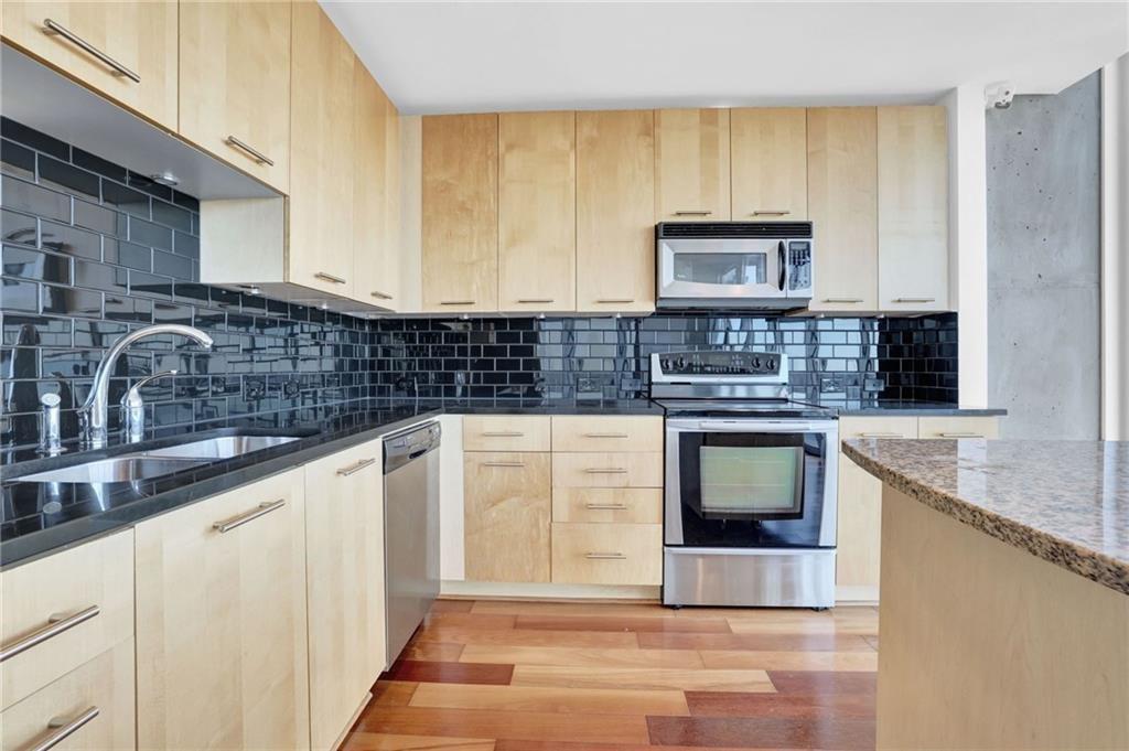 3324 Peachtree Road Northeast, Unit 2507 Atlanta, GA 30326 - Photo 7 of 25 a kitchen with stainless steel appliances granite countertop a sink stove and cabinets