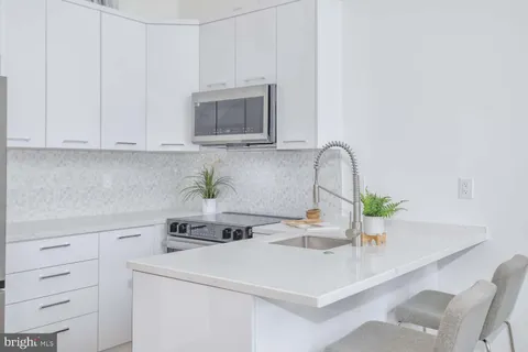 a kitchen with a white cabinets and white appliances