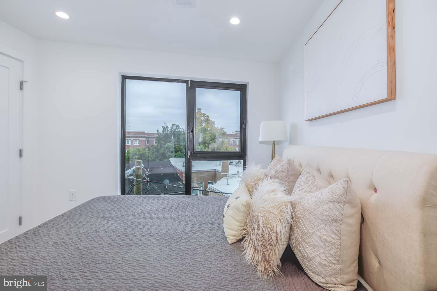 4328 Georgia Avenue Northwest, Unit 401 Washington, DC 20011 - Photo 17 of 32 a bed sitting in a bedroom next to a window