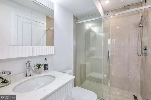 a bathroom with a sink toilet and shower