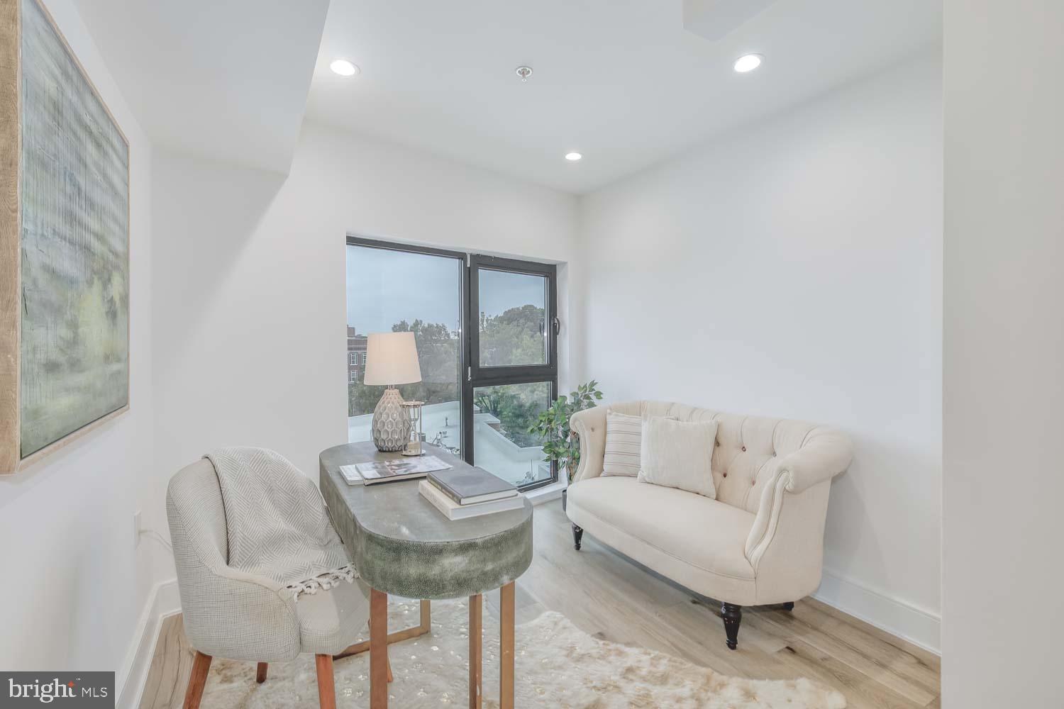 4328 Georgia Avenue Northwest, Unit 401 Washington, DC 20011 - Photo 25 of 32 a living room with furniture and a potted plant