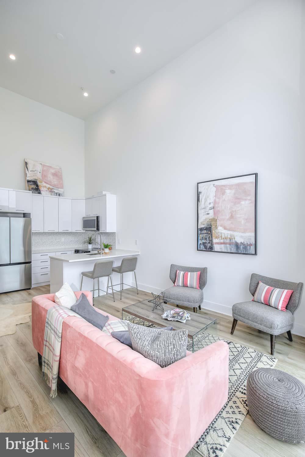 4328 Georgia Avenue Northwest, Unit 401 Washington, DC 20011 - Photo 8 of 32 a living room with furniture and a rug