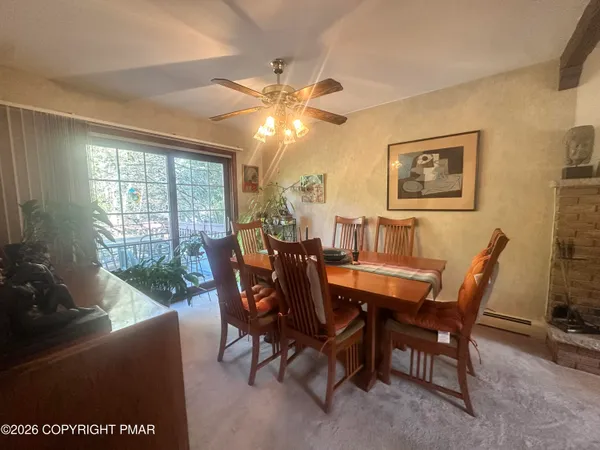 a dining room with furniture and window