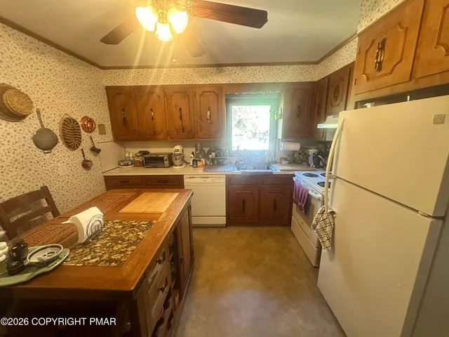 a kitchen with a refrigerator and a stove