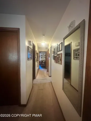 a view of a hallway with wooden floor