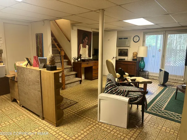 a living room with furniture a rug and a window