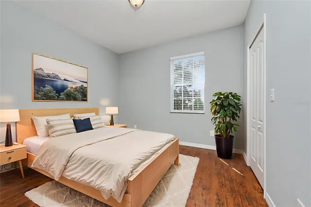 a bedroom with a bed and a window