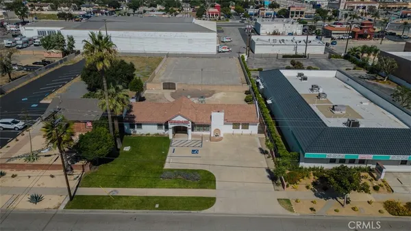 an aerial view of a house with a yard