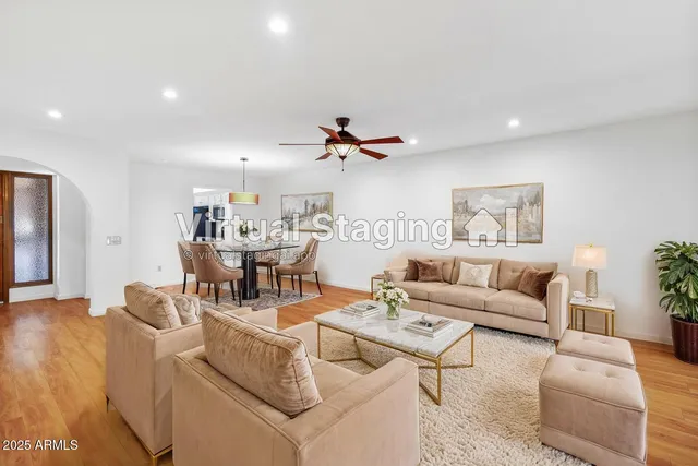 a view of a room with a wooden floor and a ceiling fan