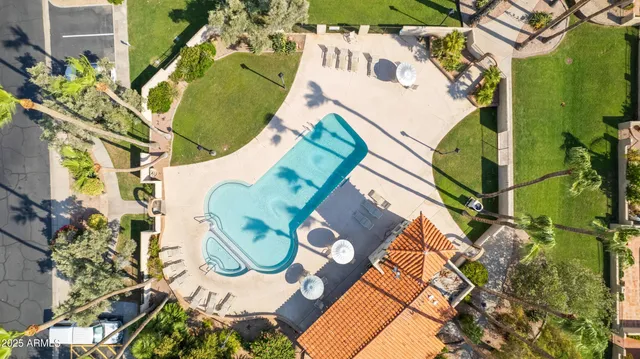 a backyard of a house with outdoor seating and trees