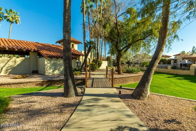 a view of a patio with table and chairs with wooden floor and fence