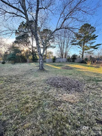 a view of a yard with large trees