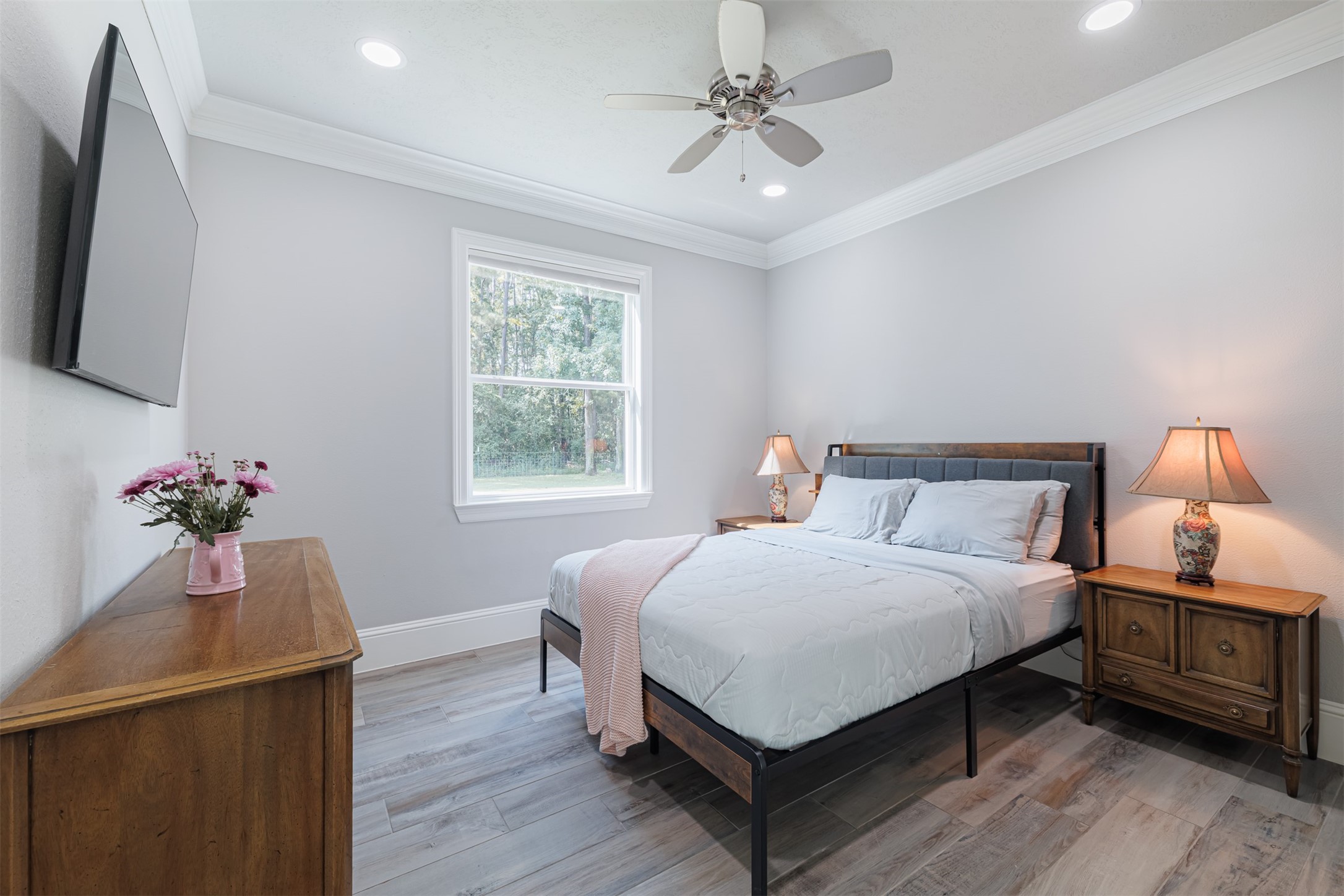 16636 Stonecrest Drive Conroe, TX 77302 - Photo 15 of 40 Bedroom 3:
Grounded in warmth and simplicity, this tranquil bedroom draws you in with soft light, fresh air, and a deep sense of calm that lingers.