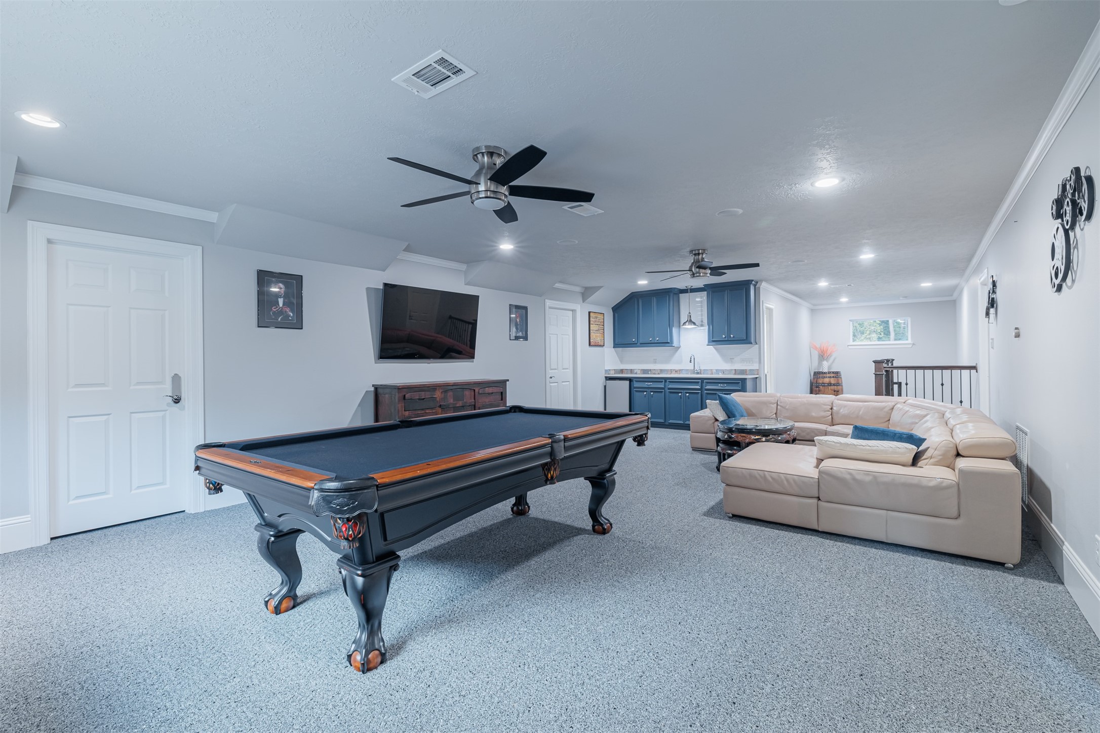 16636 Stonecrest Drive Conroe, TX 77302 - Photo 19 of 40 From competitive billiards to quiet conversations on the oversized sectional, this game room is the ultimate entertainment haven. The built-in wet bar is ready for refreshments, and the soft carpeting invites you to kick off your shoes and stay awhile. Bonus: a massive air-conditioned storage room is just around the corner!