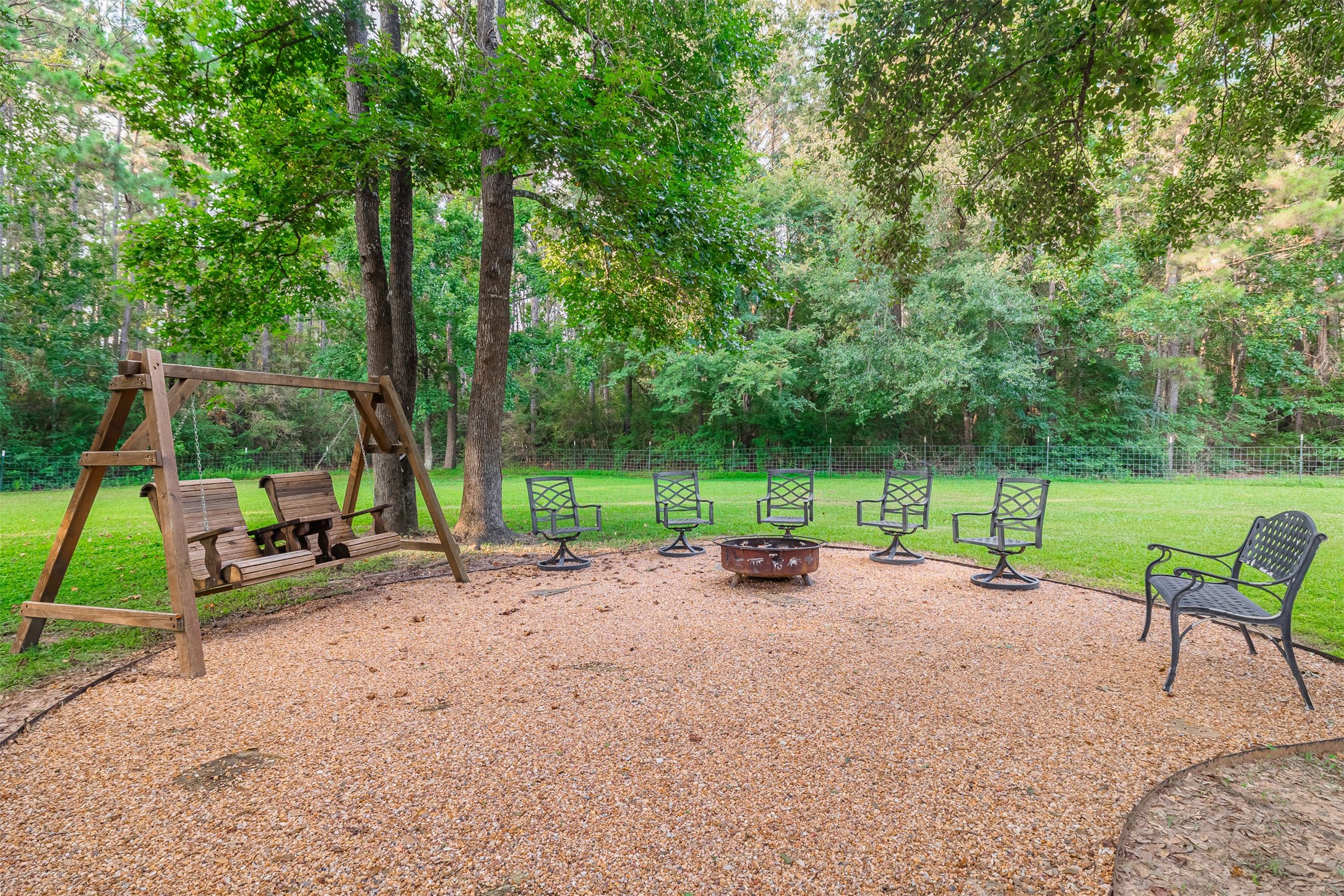 16636 Stonecrest Drive Conroe, TX 77302 - Photo 22 of 40 Feel the crunch of gravel under your feet as you gather around the firepit under a canopy of trees. S’mores in hand, kids giggling, stars overhead—it’s a backyard made for memories, stories, and stillness all at once.