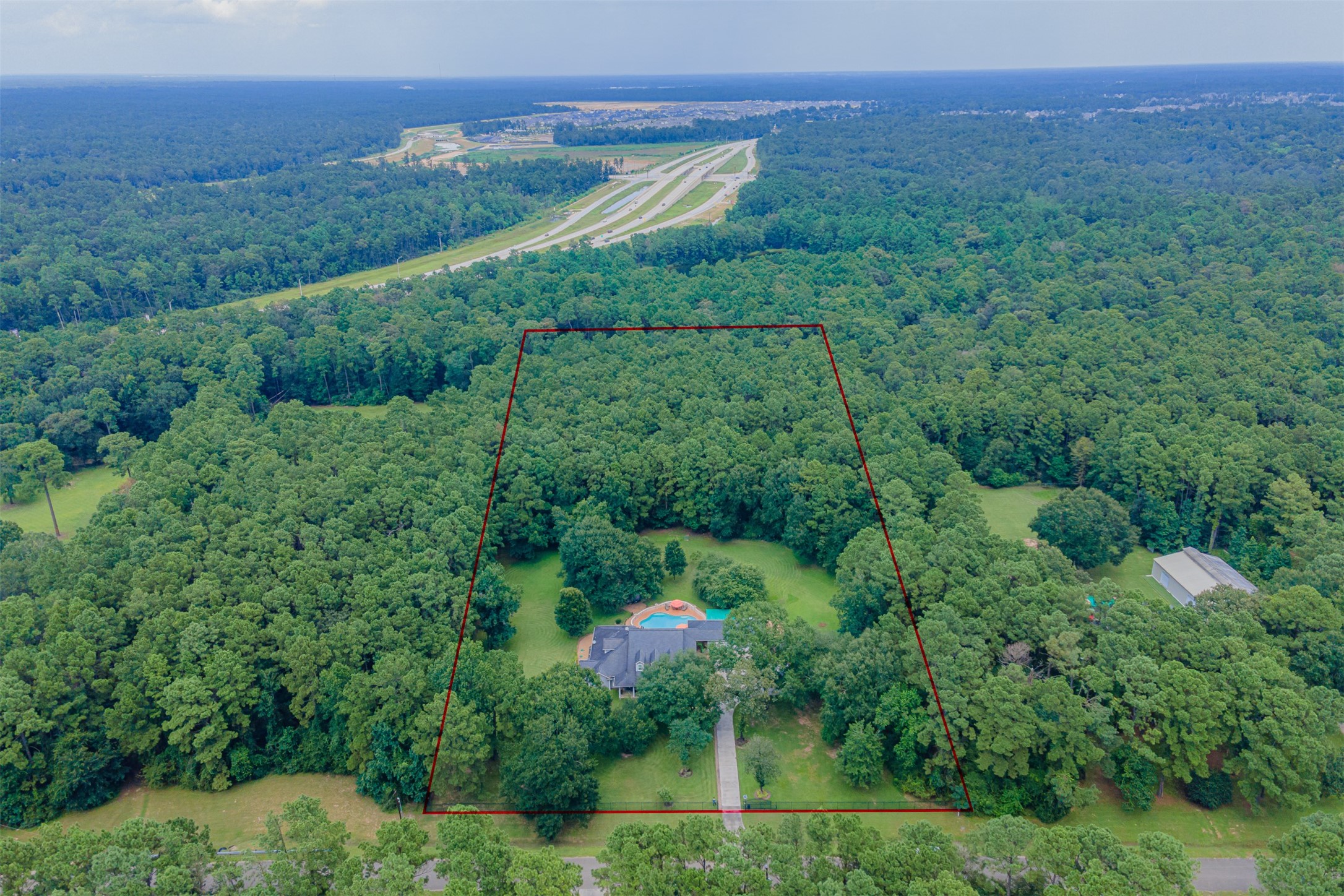 16636 Stonecrest Drive Conroe, TX 77302 - Photo 23 of 40 Step back and take in the sheer magnitude of this private sanctuary — five acres of peace, privacy, and possibility. Imagine owning not just a home, but a hidden world tucked beneath a canopy of trees, where nature and family moments intertwine.