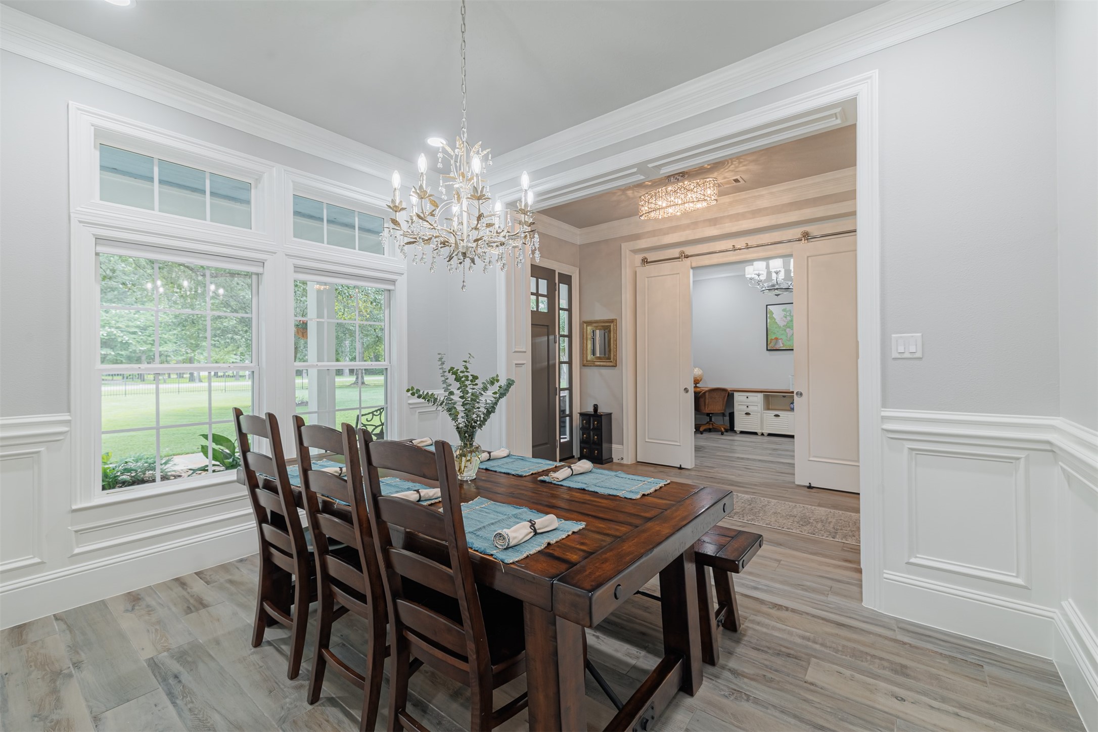 16636 Stonecrest Drive Conroe, TX 77302 - Photo 24 of 40 Gather with loved ones in the sophisticated formal dining room, illuminated by soft sunlight through generous windows and accented by intricate crown molding and an elegant chandelier.