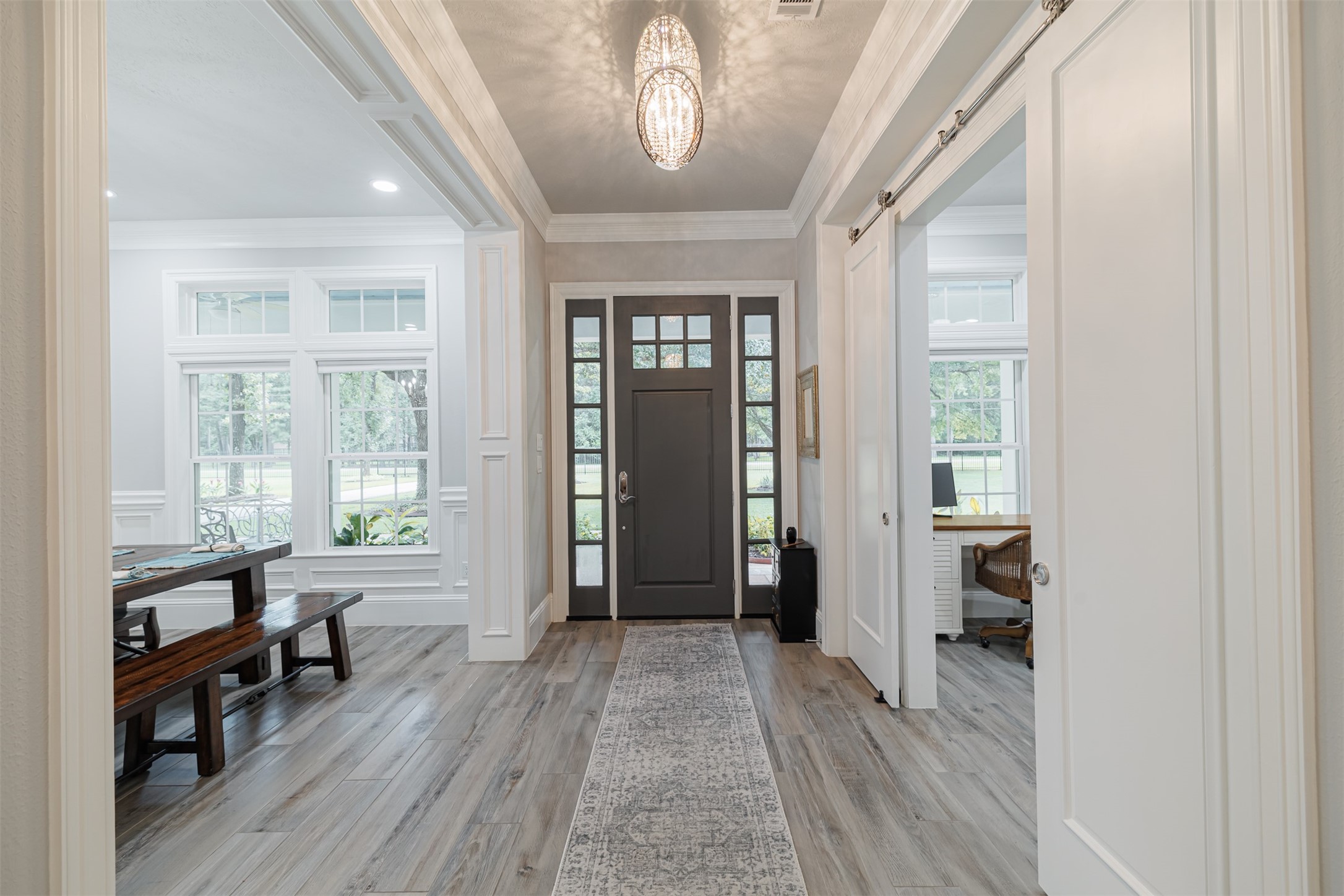 16636 Stonecrest Drive Conroe, TX 77302 - Photo 25 of 40 Inside, your eyes are immediately drawn upward to exquisite triple crown molding and dazzling custom light fixtures, as sunlight softly illuminates the spacious formal dining and private study—showcasing the home’s refined craftsmanship.