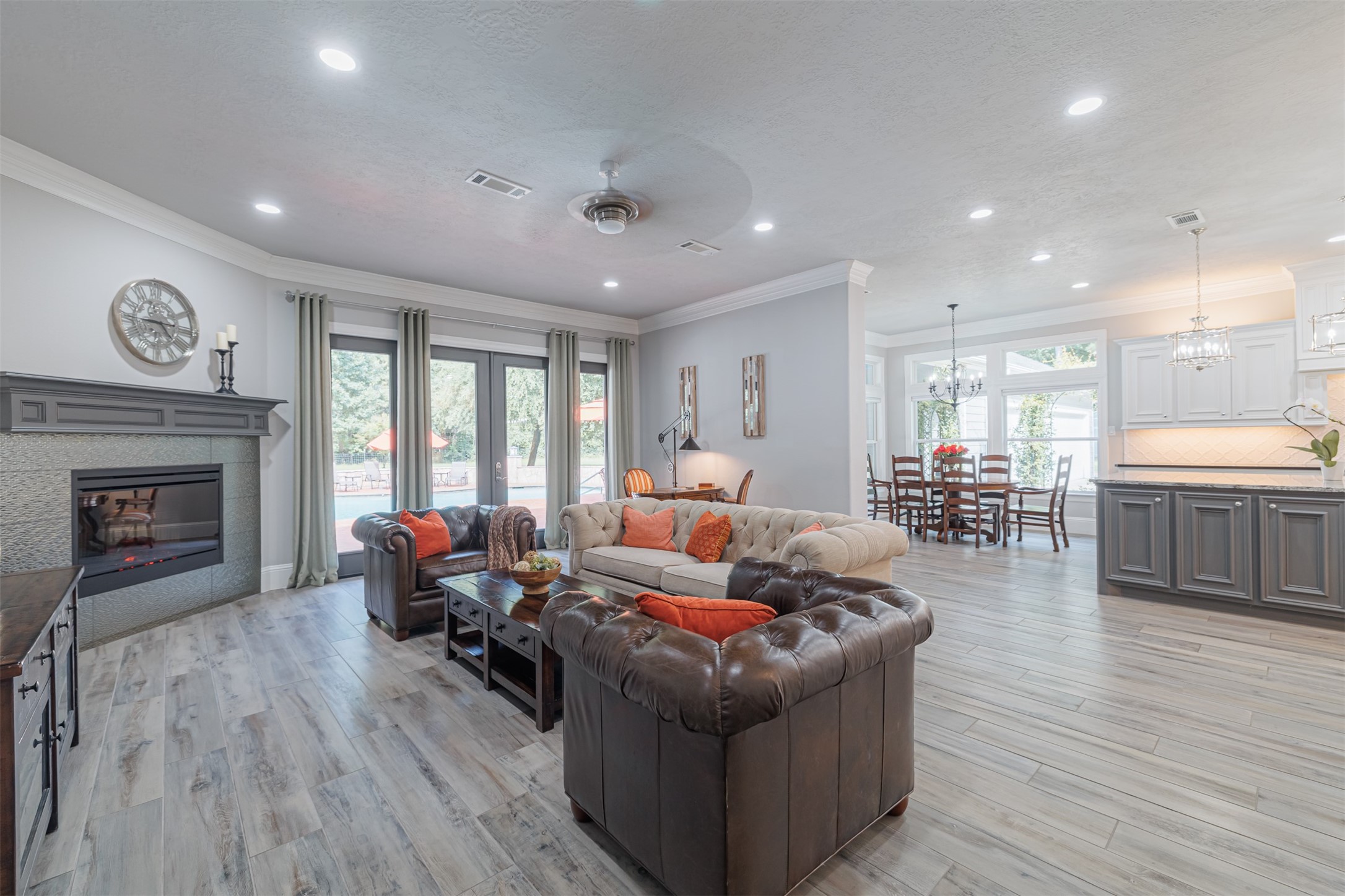 16636 Stonecrest Drive Conroe, TX 77302 - Photo 3 of 40 Relax in a spacious family room flooded with natural light, warmed by a cozy fireplace, and seamlessly connected to the kitchen—ideal for gatherings and daily comfort.