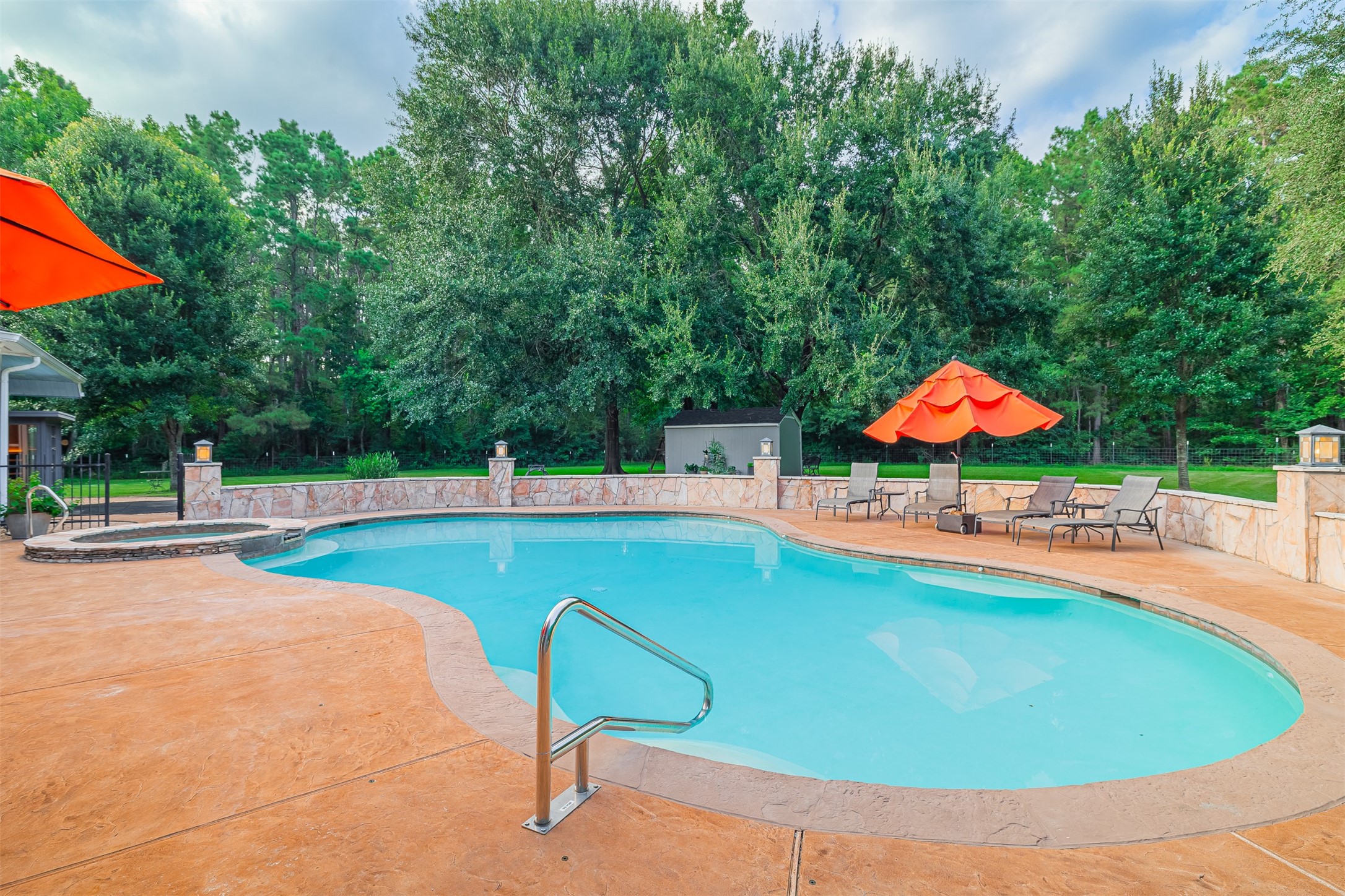16636 Stonecrest Drive Conroe, TX 77302 - Photo 32 of 40 Close your eyes and hear the gentle splash of water and rustle of leaves. This is your private escape — where morning swims awaken your soul, and lazy afternoons melt into golden evenings. The pool becomes your sanctuary — no flights, no packing — just peace steps from your door.