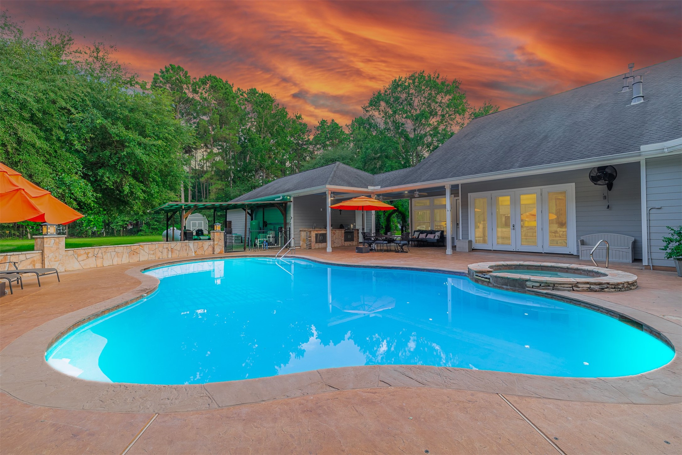 16636 Stonecrest Drive Conroe, TX 77302 - Photo 36 of 40 Imagine the sun setting behind the trees as laughter echoes across the water. The pool lights dance beneath the surface while music plays and glasses clink. This is where summer memories are made — barefoot on warm concrete, wrapped in towels, surrounded by the people you love.