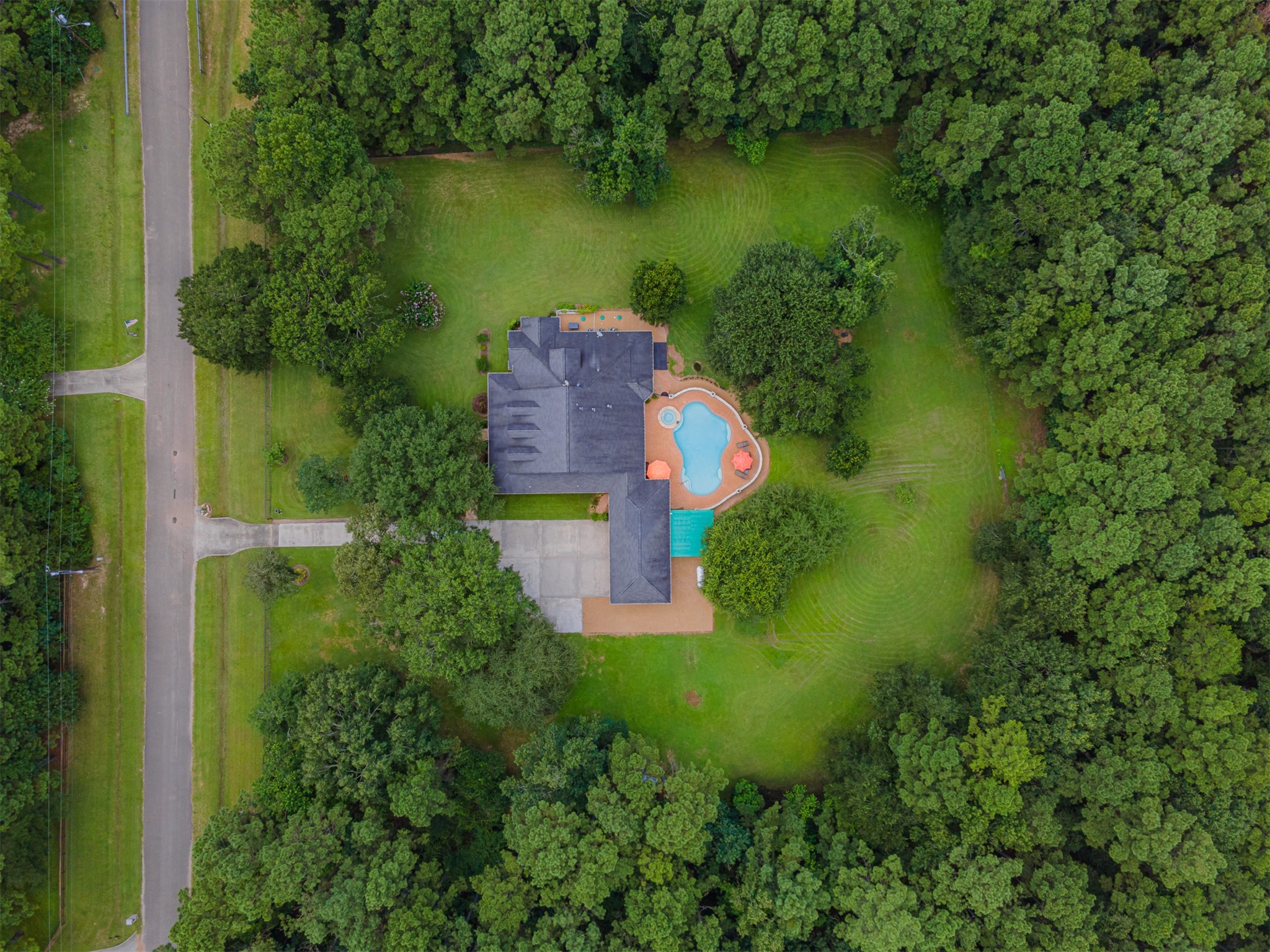 16636 Stonecrest Drive Conroe, TX 77302 - Photo 8 of 40 From above, the property reveals its private embrace—nestled in nature, surrounded by tall trees, and perfectly tucked away from the world. You can almost hear the quiet breeze and feel the calm of complete seclusion. It’s not just a home; it’s your own private retreat, where peace and privacy meet possibility.