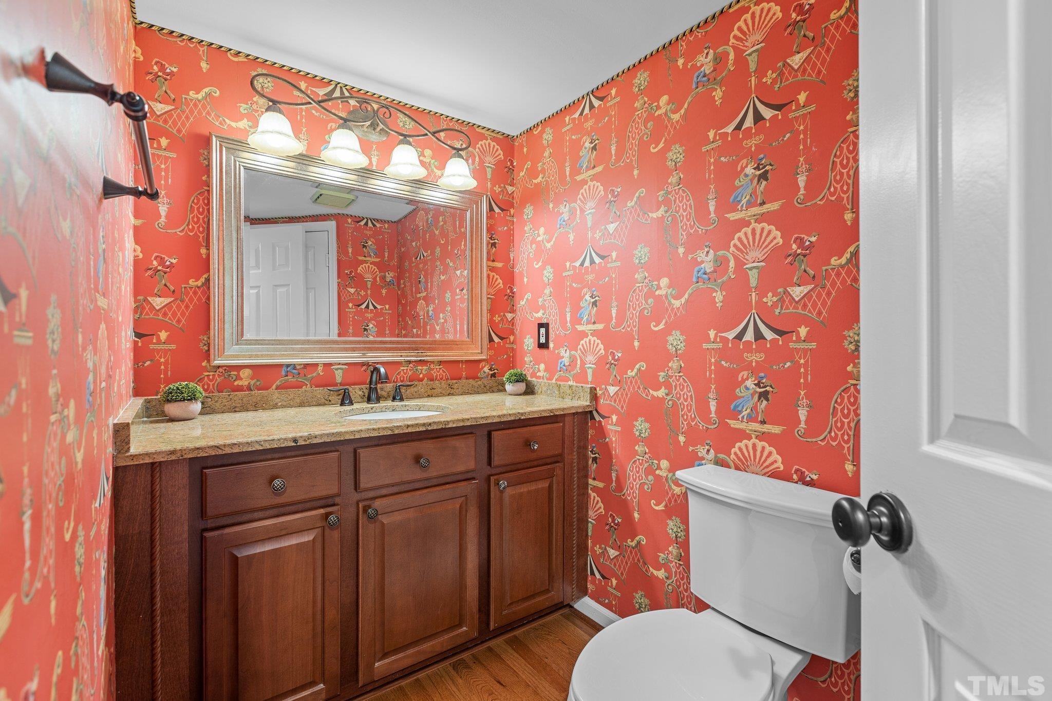 3903 Carnegie Lane Raleigh, NC 27612 - Photo 20 of 36 a bathroom with a granite countertop sink a toilet and a mirror