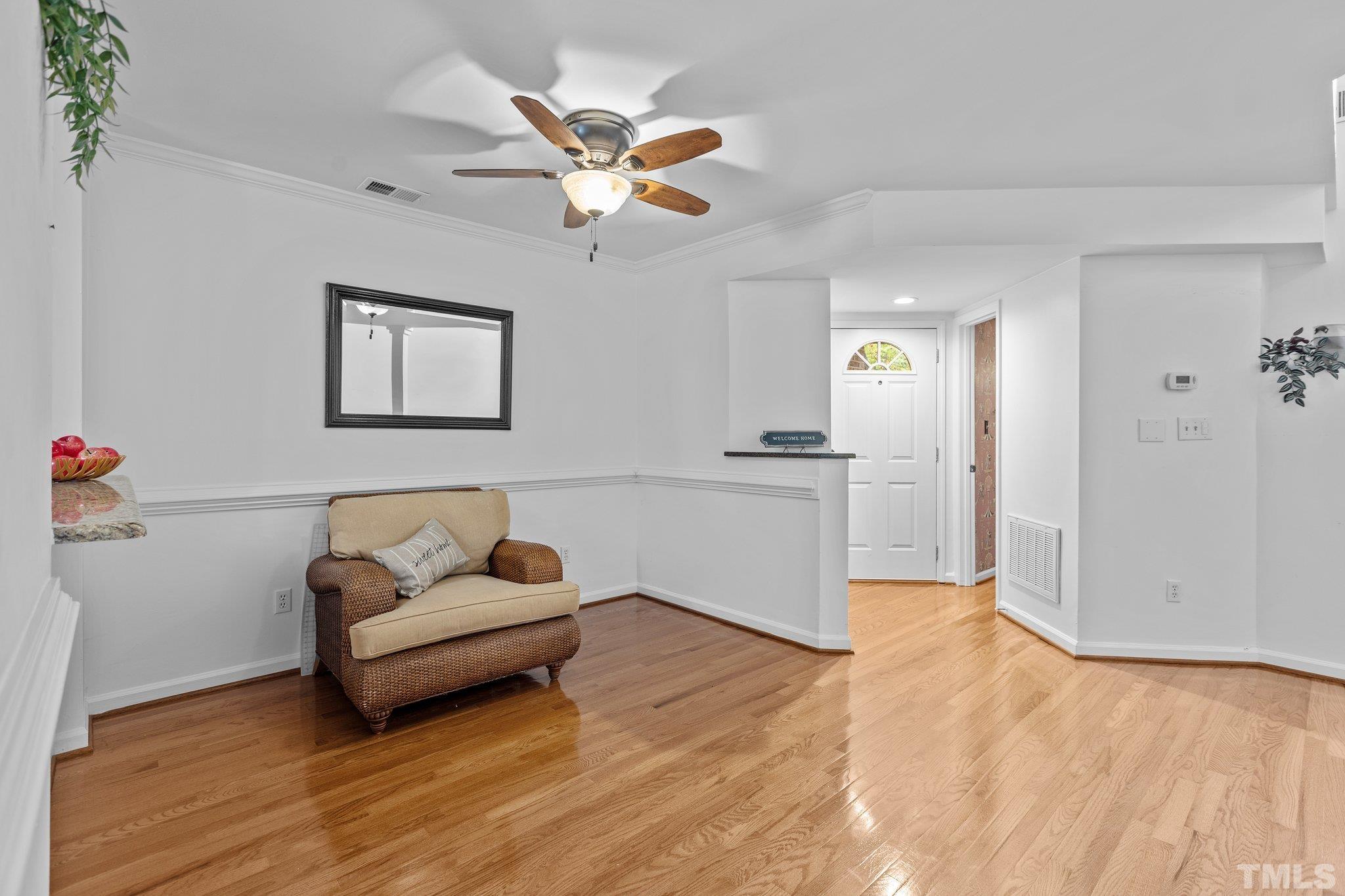 3903 Carnegie Lane Raleigh, NC 27612 - Photo 4 of 36 a living room with furniture and a wooden floor