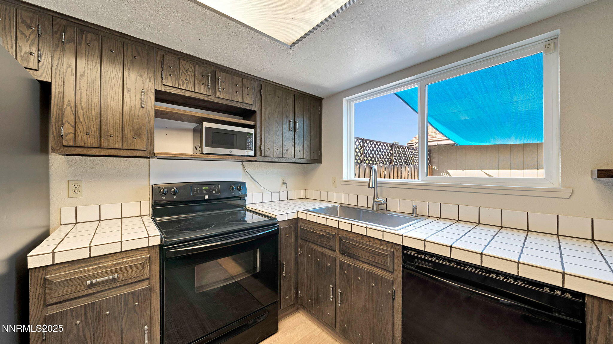1515 Foster Drive Reno, NV 89509 - Photo 27 of 50 a kitchen with a sink stove and microwave