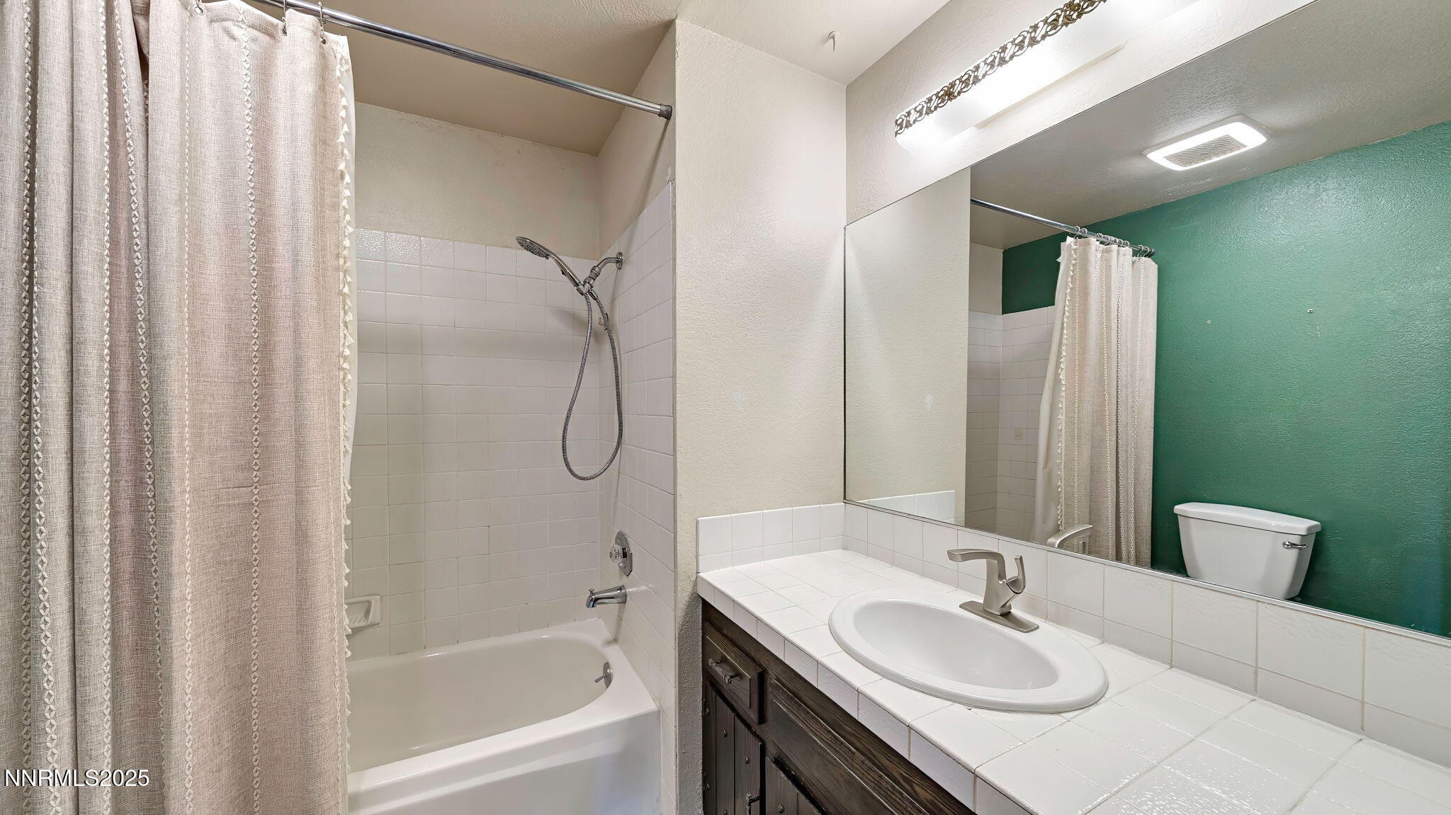1515 Foster Drive Reno, NV 89509 - Photo 40 of 50 a bathroom with a granite countertop sink and a mirror
